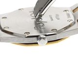 a close up of a watch on a white surface
