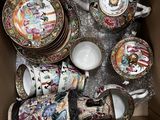 une boîte remplie d'assiettes, de tasses et de soucoupes de toutes sortes