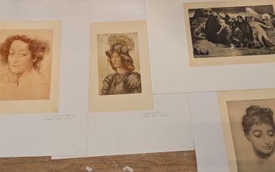 many old photographs of women on display on a table