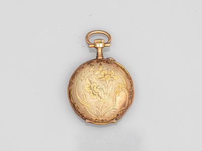 an image of a gold pocket watch with a floral design on it