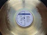 gold record in a display case with a label on it