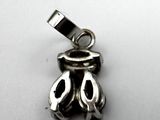 a close up of a silver charm on a white surface