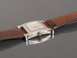 a close up of a wrist watch with a brown leather strap