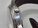 a close up of a watch with a leather band