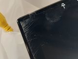 a laptop with a broken screen sitting on a table
