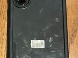 an image of a black phone sitting on top of a wooden floor