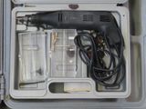 a box with a drill and other tools inside of it