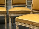 four chairs are lined up in a row on the floor