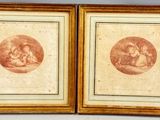 two framed prints of a woman and child on a wall