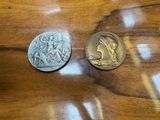 two coins sitting on a wooden table next to each other