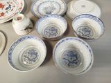 many plates and bowls that are sitting on a table