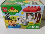 a box of lego duplo animals and a dog house