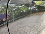 a reflection of a person in the side mirror of a car