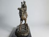 bronze statue of a man on a horse with a spear in his hand