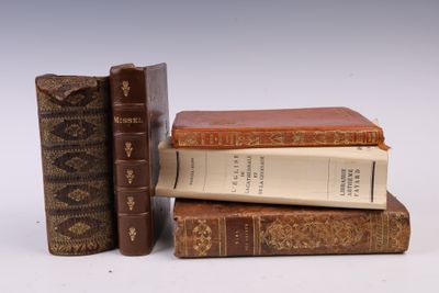 trois livres sont empilés sur une surface blanche