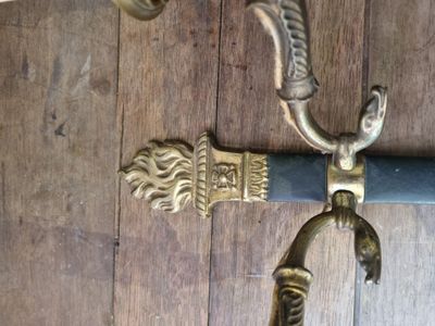 a close up of a knife and a handle on a wooden floor
