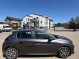 a grey car parked in a parking lot next to a building