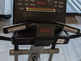 a laptop sitting on top of a treadmill in a gym