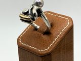 sterling silver frog ring on leather box on white background