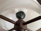 a lamp that is on a wooden stand with a glass shade