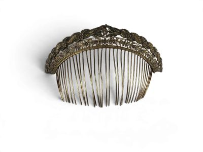a hair comb that is sitting on a white surface