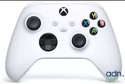 a close up of a white xbox controller on a white surface