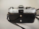 a black and white photo of a camera on a table