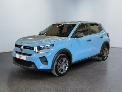 the blue suv is parked in a white room with a black floor