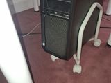 a computer on a stand in the middle of a room