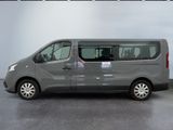 the grey van is parked in the garage with its door open