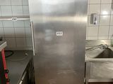 a stainless steel refrigerator in the middle of a kitchen