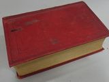 a red book sitting on top of a white table