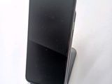 a cell phone that is sitting on top of a stand