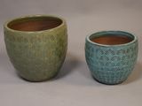 two pots sitting next to each other on a table