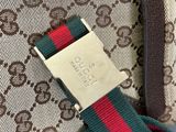 a close up of a bag with a red, green and blue strap