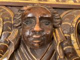 a close up of a statue of a man on a wall
