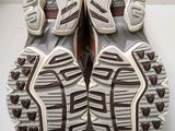 pair of white and brown running shoes on a white surface