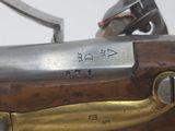 an old gun with a brass handle and a wooden body