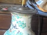 a vase that is sitting on a table with a horn on it