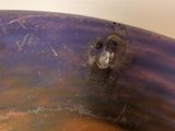 a close up of a metal object with a hole in it