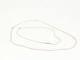 a close up of a necklace on a white surface with a white background