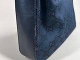 a blue guccissi bag sitting on top of a white table