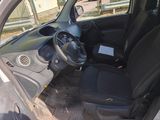 the interior of a small car with a steering wheel and seat covers