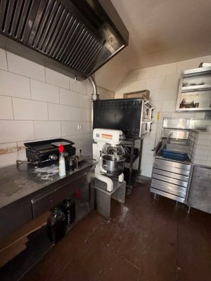 a kitchen with a stove, oven, sink, and cabinets