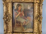 painting of a woman sitting in a chair in a gold frame