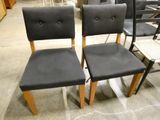 two black chairs sitting next to each other in a room
