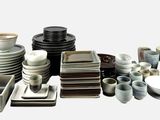 a lot of plates and bowls and bowls on the table
