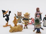 many figurines of different characters on a white surface