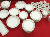 a red table with many plates and bowls on it