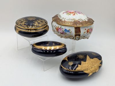 three black and gold decorated boxes on clear acrylic stands